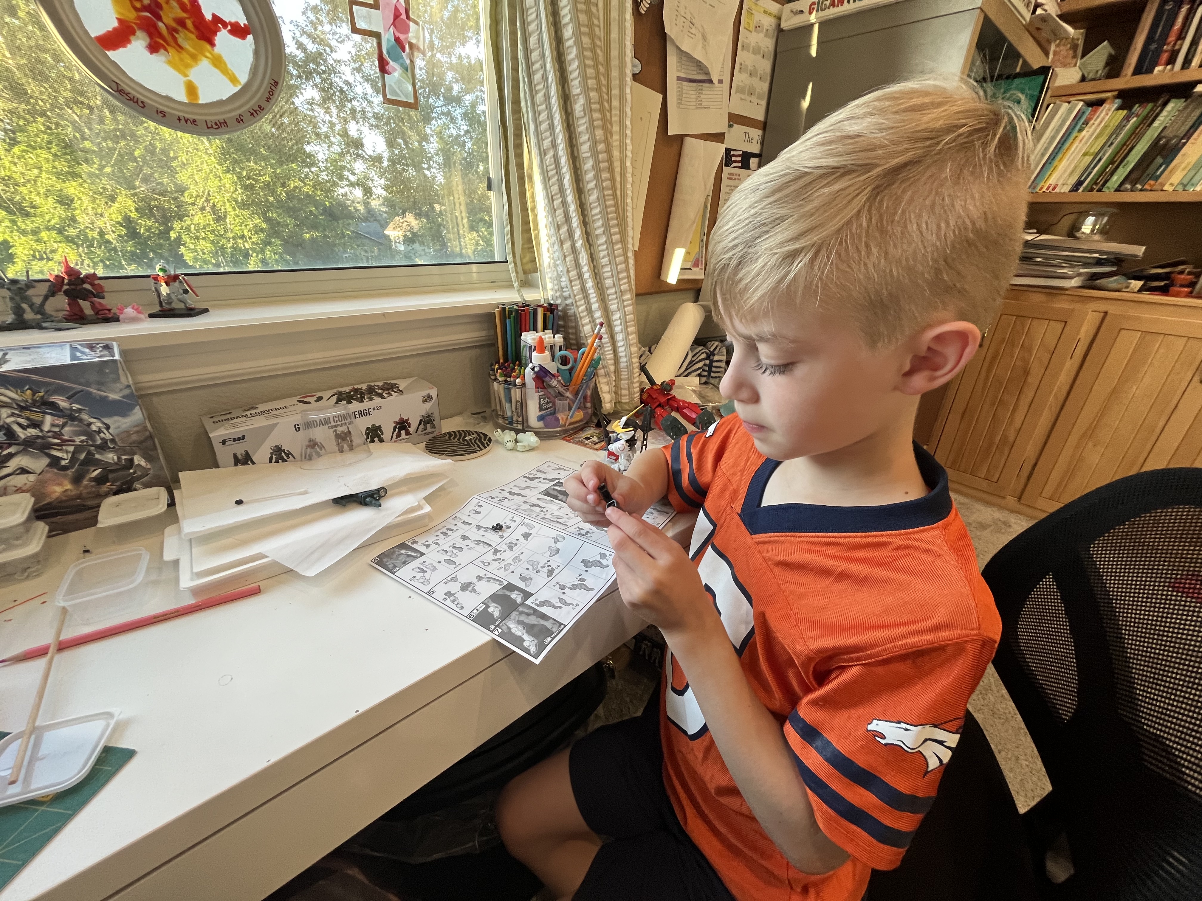 A few kits in, my son working on an HG Barbatos